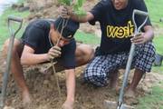 +2 students participating in tree planting program