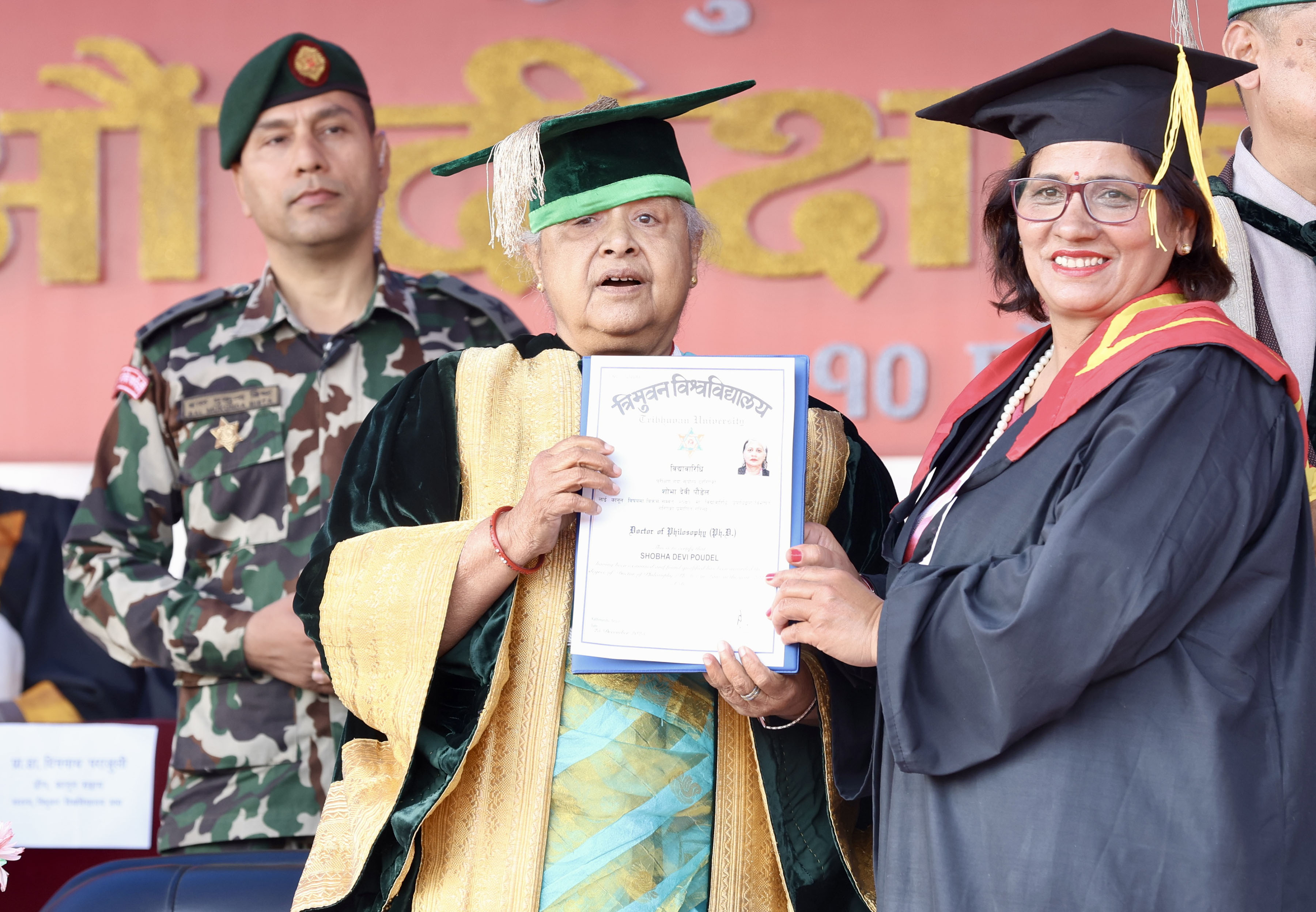 Prime Minister and Tribhuvan University Chancellor Sushila Karki presenting a PhD certificate in Law to Shobha Devi Poudel during the university's 51st Convocation ceremony held today at Dasharath Stadium, Kathmandu.